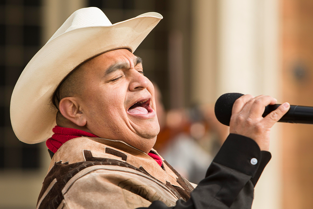 Image of Francisco Ramirez singing in front of City Hall.